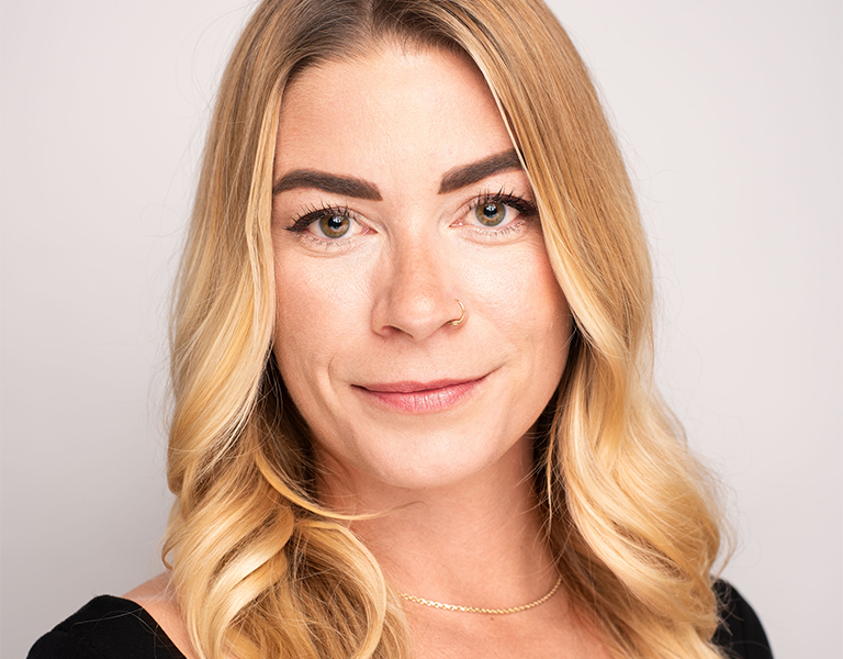 a woman with long blonde hair smiling into the camera; Erin George, The Bail Project's National Director of Policy