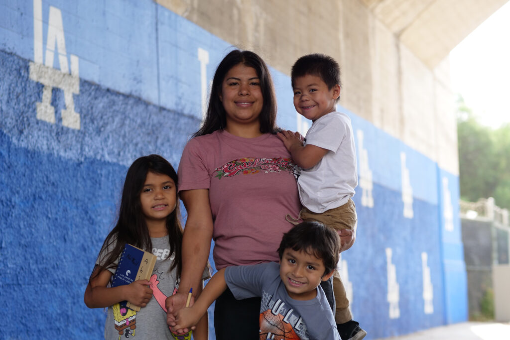 Los Angeles client, Sandra, with her three kids, in front of LA Dodgers logos.