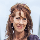 a woman with long hair is smiling for the camera.