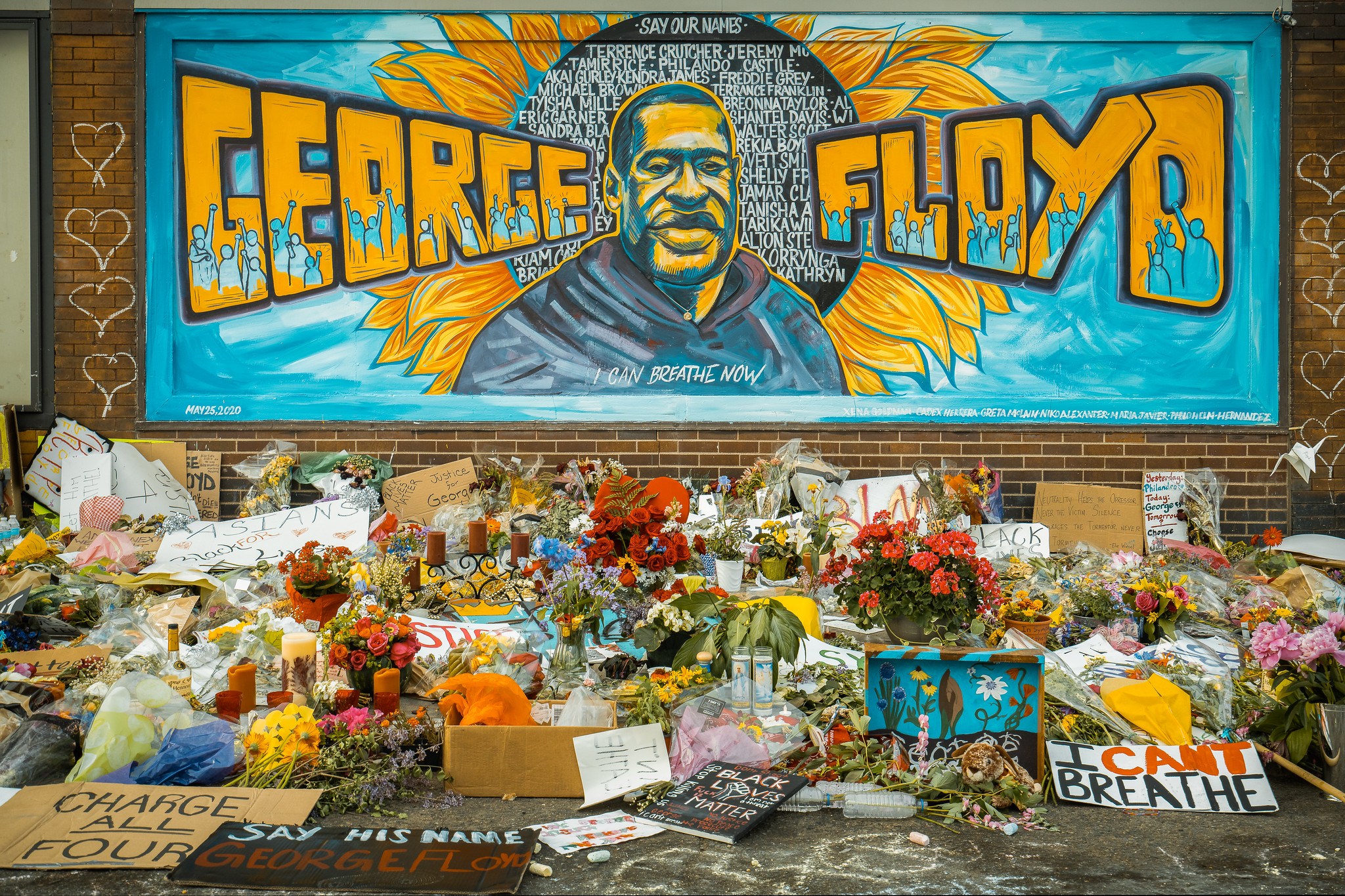 George Floyd mural surrounded by flowers and signs; IMAGE: flickr Chad Davis CC BY-SA 2.0