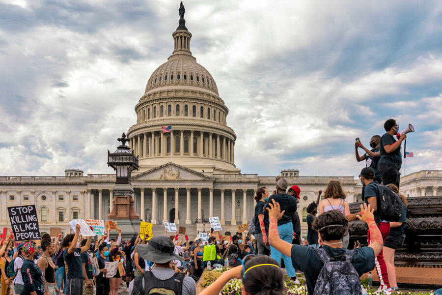 A crowd protesting in front of the capitol building.