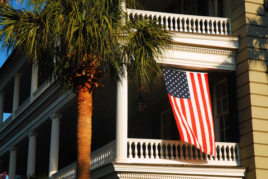 an american flag hanging from the side of a building.