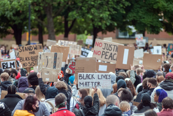 a large group of people holding signs in a protest.