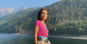 Bail Project client, Ontequa, in colorful clothing standing in the sunshine in the mountains