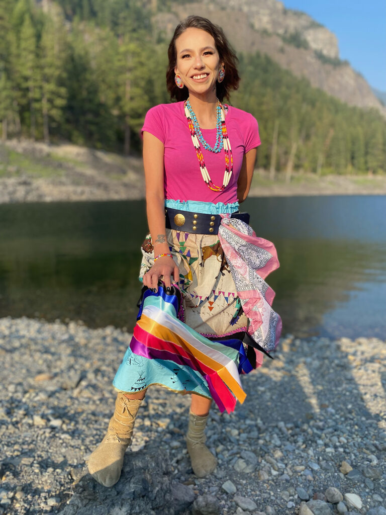 Bail Project client, Ontequa, in colorful clothing standing in the sunshine in the mountains