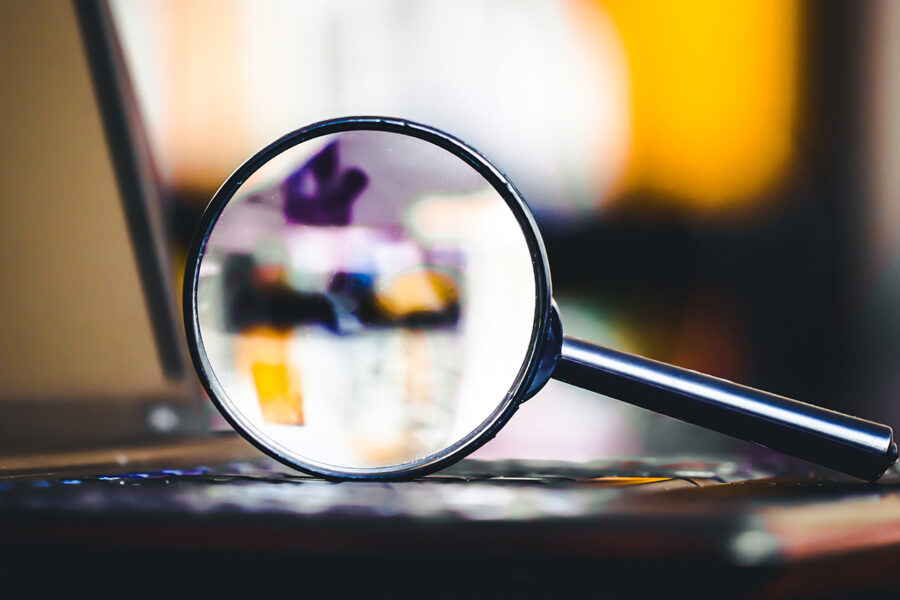 A magnifying glass on a laptop, bringing colors and shapes into focus while studying cash bail data