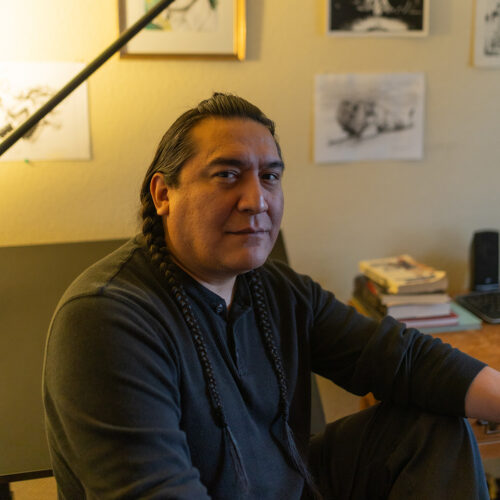 Bail Project client Antoine smiling inside surrounded by art