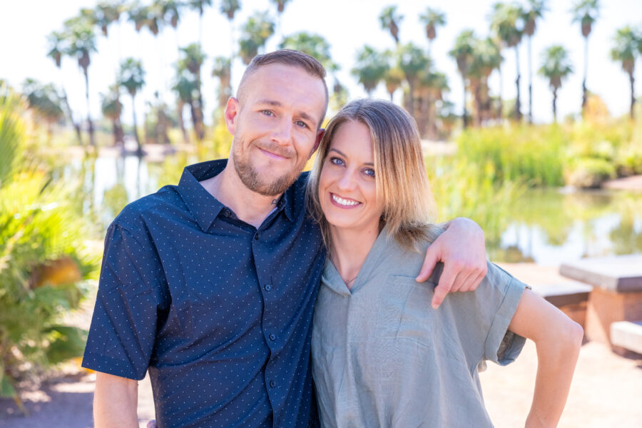 Bail Project client Michael standing outside with his sister, amongst trees, smiling