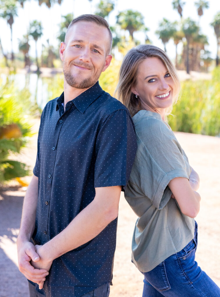 Bail Project client Michael standing outside with his sister, amongst trees, smiling