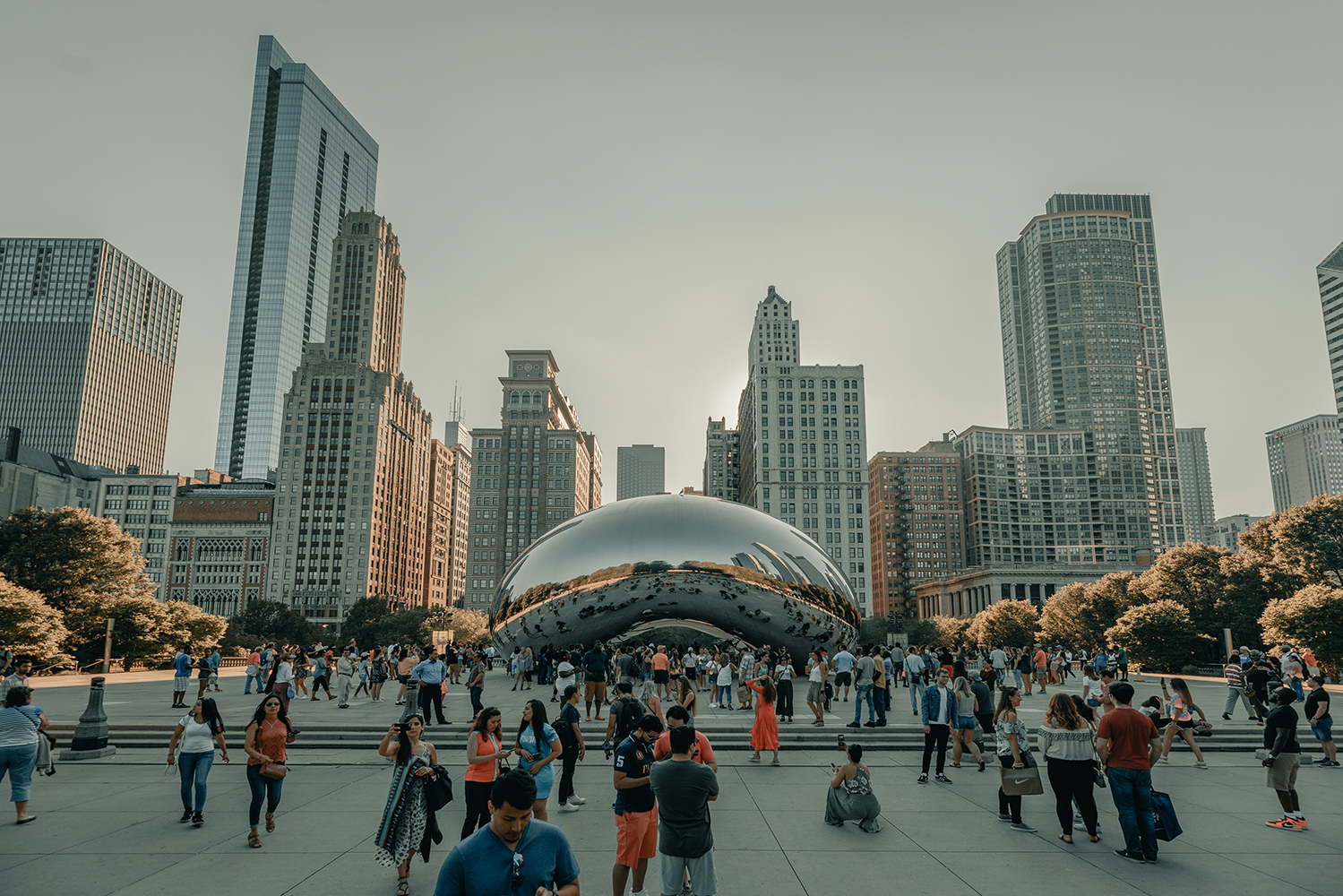 Chicago's Bean surrounded by people and buildings