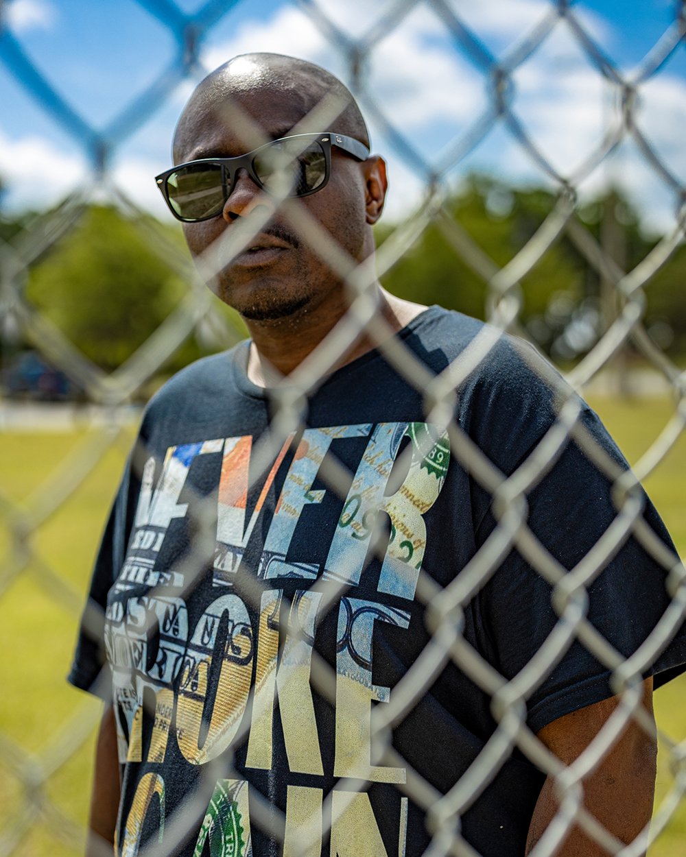 Charles behind a fence, talking about the War on Drugs