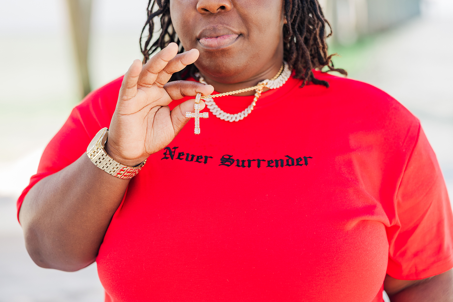 On a Pensacola beach, Latranda holds up the cross on her necklace